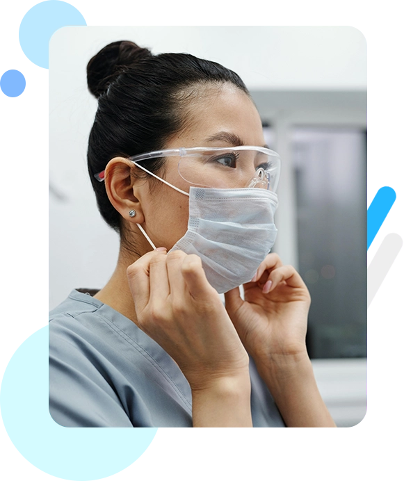 A woman putting on her surgical mask