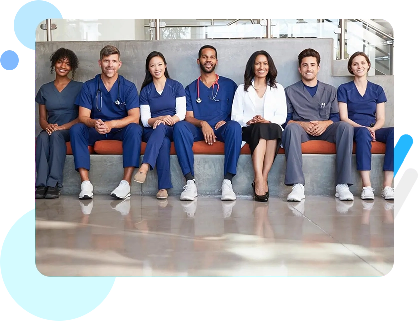 A group of doctors sitting on top of a bench.